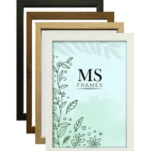 May include: A selection of rectangular picture frames in black, brown, light brown, and white. The frames are stacked, showing their different colours. The text "MS FRAMES" is displayed on a light blue background.