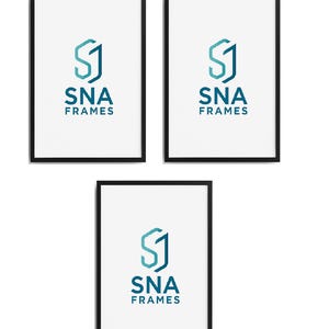 May include: Three black framed art prints with white backgrounds. Each print features a teal and blue geometric logo with the text "SNA FRAMES" in teal. The frames are rectangular and arranged in a vertical and horizontal layout.