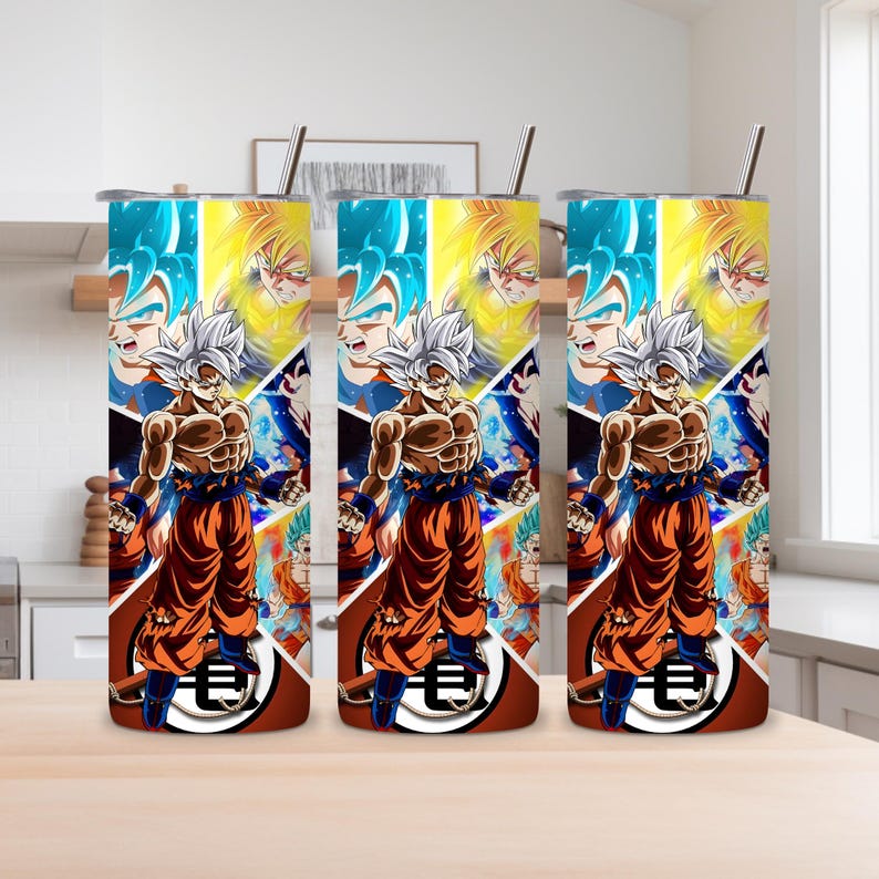 May include: Three stainless steel tumblers with a colorful anime-style design. Each tumbler features a central image of a muscular character in orange and blue attire, with a silver straw. The background is a collage of character images.
