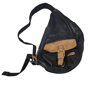 May include: A black leather crossbody bag with a brown leather flap and a buckle closure. The bag has a small pocket on the front with the text "Lands' End" printed on it.