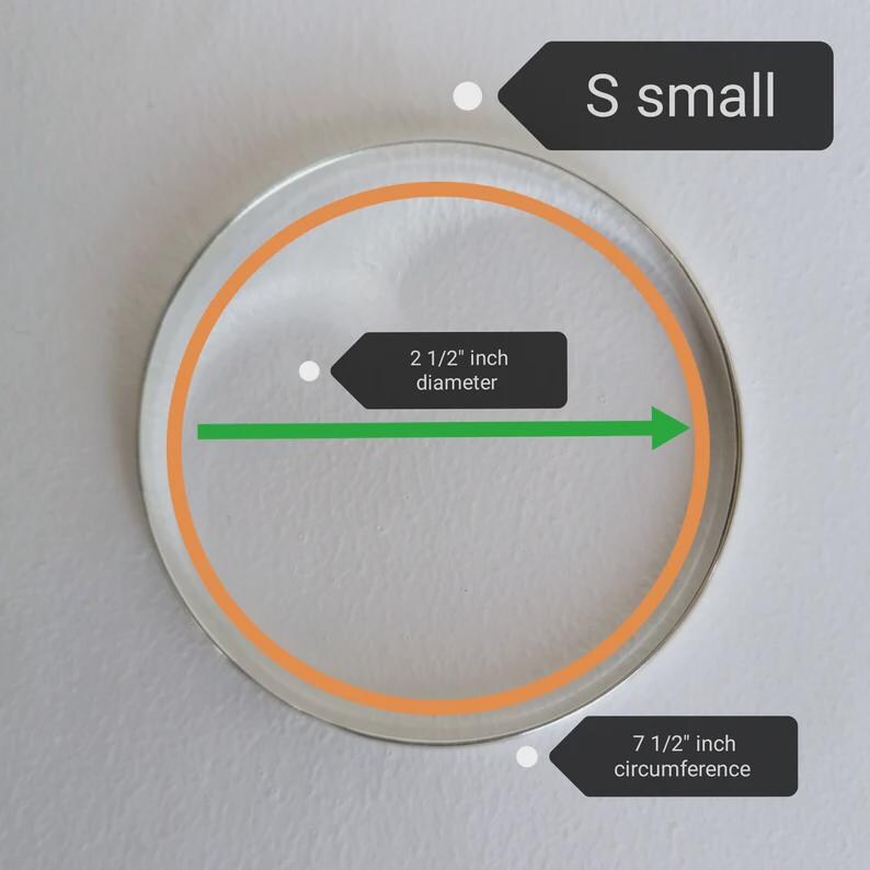 May include: A clear, circular object with an orange outline and a 2 1/2 inch diameter. The circumference is 7 1/2 inches. The text "S small" is displayed above the object.