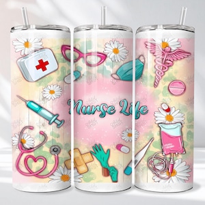 May include: A white tumbler with a straw, decorated with medical-themed illustrations. The design includes a first aid kit, syringe, stethoscope, daisies, and the words "Nurse Life" in a script font. The background has a pink and yellow watercolor effect.