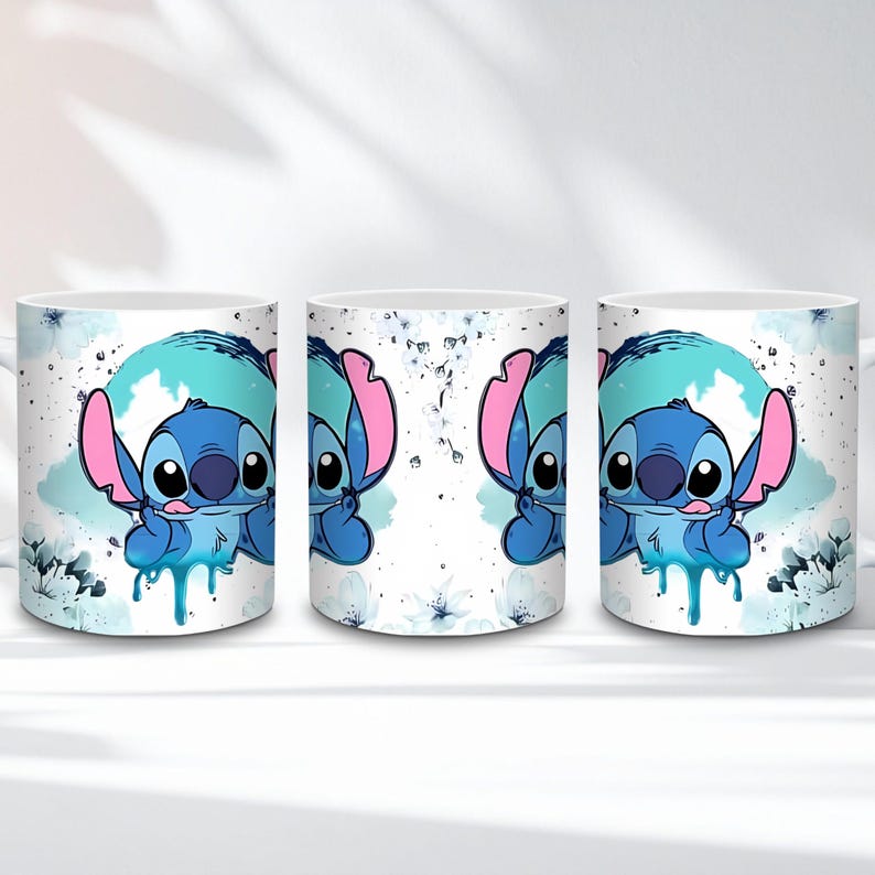 May include: White ceramic mug featuring a blue cartoon character with large ears and a blue and pink color scheme. The character is set against a blue and white background with floral accents. The mug has a handle.