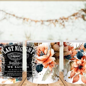 May include: White ceramic coffee mugs with floral designs and text. One mug features the words "LAST NIGHT" and "WE SAID" with a liquor-themed design. The other mugs have watercolor-style orange and blue floral patterns.
