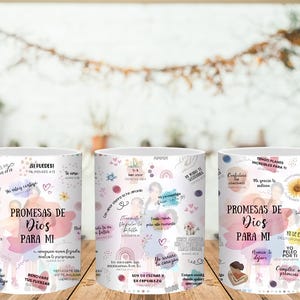 May include: White ceramic mugs with a wraparound design featuring the text "PROMESAS DE DIOS PARA MI" in Spanish, surrounded by inspirational quotes, floral accents, and watercolor-style graphics. The mugs are displayed on a wooden surface.