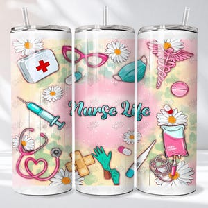 May include: A white tumbler with a straw, featuring a colorful design with medical-themed illustrations. The design includes a first aid kit, syringe, stethoscope, and the words "Nurse Life". Daisies and medical symbols are also present.
