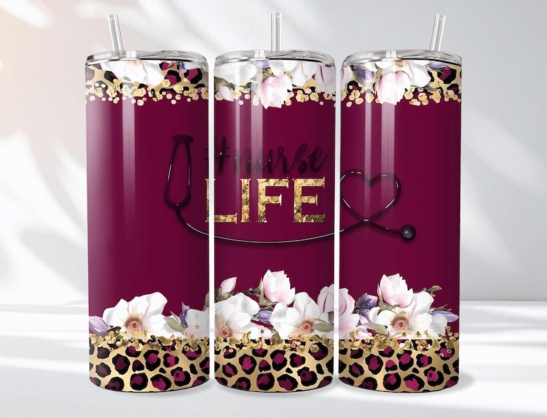 May include: A maroon tumbler with a floral and leopard print design. The tumbler features the words "Nurse LIFE" in gold lettering, a stethoscope graphic, and white flowers.