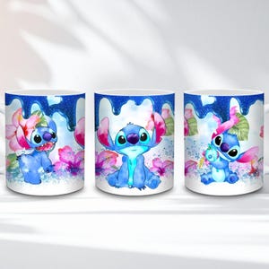 May include: White ceramic mug featuring three different images of the blue alien Stitch from Lilo & Stitch. Each mug design includes Stitch with pink flowers and a blue glittery drip design.
