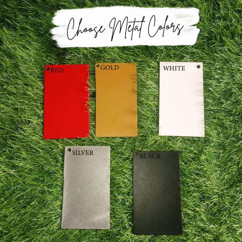 May include: Five metal color samples: red, gold, white, silver, and black. Each sample is a rectangular shape with a small hole at the top. The text "Choose Metal Colors" is written in cursive above the samples.
