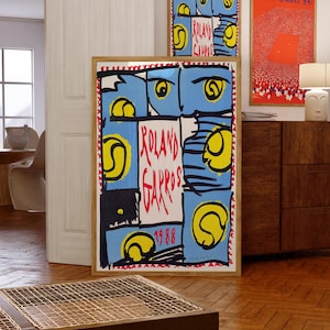 May include: Three framed art prints with tennis-themed designs. The largest print features the text "Roland Garros 1988" in a bold, colorful design. The other prints have similar themes, with blue, yellow, and red accents.
