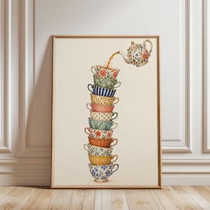 May include: A framed wall art print featuring a watercolor illustration of a floral teapot pouring tea into a vertical stack of eleven uniquely patterned and colored teacups. The cups display various designs including stripes, dots, and floral motifs.