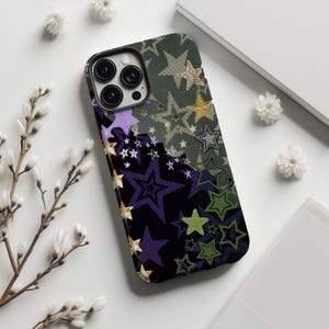 May include: A smartphone case with a star pattern in shades of green, purple, and gold. The case has a black border and a camera cutout. The design features various star shapes and sizes, creating a collage effect.