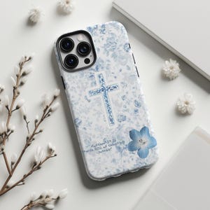 May include: A white ceramic mug with a black handle and the text "But First, Coffee" in a handwritten style. The mug is on a white surface. The mug is likely for hot beverages.