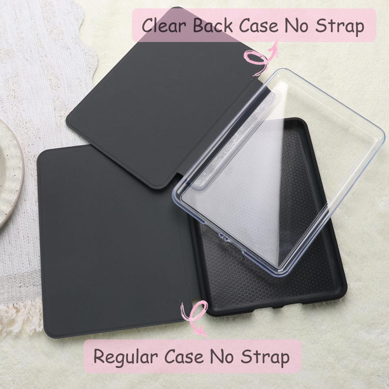 May include: A black tablet case with a clear back case, and the text "Clear Back Case No Strap" and "Regular Case No Strap". The case is open, revealing the interior. The background is a light, textured surface.