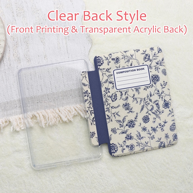 May include: A clear, transparent acrylic phone case next to a floral-patterned notebook-style phone case. The floral pattern is white with blue flowers and leaves. The notebook case has a blue spine and the words "COMPOSITION BOOK" on the front.