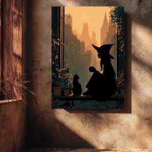 May include: A framed art print depicts a witch silhouette with a cat, seated by a window overlooking a city skyline. The artwork features warm tones of orange and brown, with potted plants on the windowsill. The witch is holding a cup.
