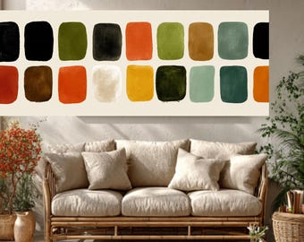 May include: Abstract art print featuring a series of colorful, rounded squares in shades of black, orange, green, and brown against a cream background. The artwork hangs above a bamboo sofa with beige cushions.