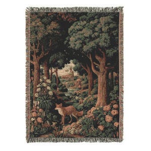 May include: Woven tapestry throw blanket featuring a forest scene with a fox. The blanket has a detailed design with trees, flowers, and a small stream. The color palette includes shades of green, brown, and beige, with a fringed edge.