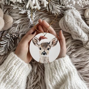 Cute Christmas Deer Santa Hat Ornament | Round Ceramic Holiday Tree Decoration | Reindeer Christmas Ornament Gift for Festive Decor