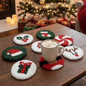 May include: A collection of Christmas-themed coasters in various designs, including a Santa suit, holly, a gift, and a reindeer. The coasters are white with red and green accents, and a mug of hot chocolate sits on one. The scene is set on a wooden table with a Christmas tree in the background.