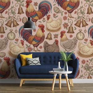 May include: A navy blue sofa with cushions is placed against a wall adorned with a repeating pattern of roosters, hens, bells, eggs, and flowers. A small white table with a vase and candle is in front of the sofa.