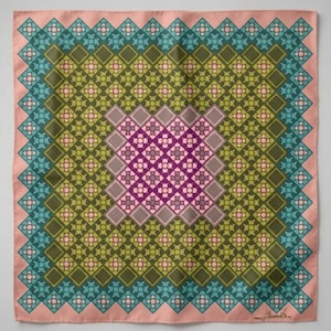 May include: A square silk scarf with a geometric pattern. The design features a central square of purple and gray floral shapes, surrounded by layers of olive green, teal, and pink diamond and floral patterns. The scarf has a pink border.