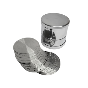 May include: A stainless steel herb grinder with a cylindrical body and a stack of perforated, circular screens. The grinder has a lid and a base, and the screens are designed to filter herbs. The items are on a white background.