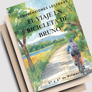 May include: A stack of books with the top cover featuring a watercolor illustration of a person riding a bicycle on a path. The book title is "El Viaje En Bicicleta De Bruno". The cover has green trees and a blue sky.