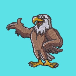 May include: An embroidered patch featuring a cartoon bald eagle with brown feathers, a white head, and a yellow beak. The eagle is standing with one wing extended outward and the other tucked against its body, showcasing detailed stitching.
