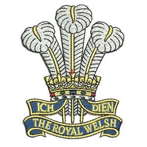 May include: Embroidered emblem featuring a gold crown with three white and yellow plumes. A blue banner below reads "ICH DIEN" and "THE ROYAL WELSH" in gold lettering. The design is set against a white background.