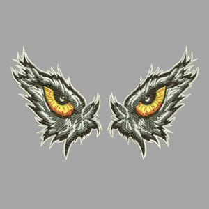 May include: Embroidered patch featuring a pair of stylized owl eyes. The eyes have yellow irises with red accents, set against a dark gray background. The design includes detailed feather-like textures and a white border.