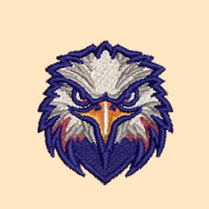May include: An embroidered patch featuring the head of a bald eagle. The design uses white, grey, and dark blue thread to define the feathers, with a bright yellow and orange beak. The eagle has a sharp, focused expression with dark blue outlines.