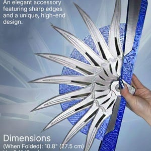 Może przedstawiać: Ozdobny wachlarz ze srebrnymi segmentami w kształcie ostrzy i niebieską, teksturowaną rączką. Tekst głosi: DECORATIVE FAN, An elegant accessory featuring sharp edges and a unique, high-end design. Wymiary (po złożeniu): 27,5 cm wys. x 8 cm szer. x 4,5 cm gł. Materiał: Premium silk PLA (Polymer).