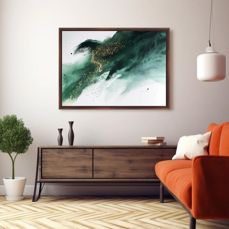 May include: Abstract painting with a green and gold color scheme. The painting is framed in a dark wood frame and is hanging on a white wall above a wooden dresser.