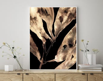 May include: A vertical rectangular wall art print featuring a high-contrast botanical illustration of elongated, weathered leaves in shades of metallic gold and bronze set against a solid, deep black background, framed in a thin white border.