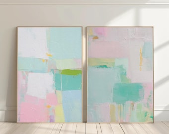 May include: Two rectangular wall art pieces featuring abstract compositions of layered paint. The color palette includes soft pastel pink, mint green, pale yellow, and white, applied with visible brushstrokes and textured impasto techniques.