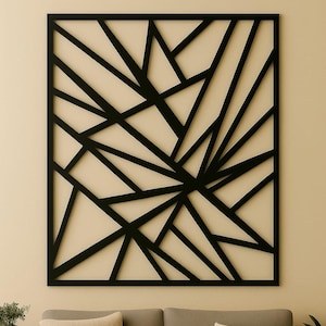 May include: A black geometric wall art piece with a square frame. The design features intersecting black lines creating an abstract pattern against a cream background. The artwork is mounted on a cream wall.