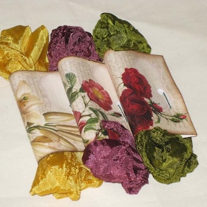 May include: Four fabric-wrapped gift boxes with floral designs and a vintage aesthetic. The boxes are tied with yellow, green, and burgundy ribbons.