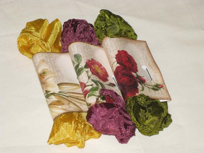May include: Four fabric-wrapped gift boxes with floral designs and a vintage aesthetic. The boxes are tied with yellow, green, and burgundy ribbons.