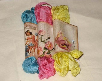 May include: Three fabric-covered cones with floral designs and a girl holding a basket of flowers. The cones are wrapped in blue, pink, and yellow fabric.