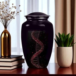 May include: A black cremation urn featuring a red DNA helix design. The urn has a lid and a shiny surface. The DNA helix is depicted with a sparkly texture against a dark backdrop. The text "kingumade ©" is visible.