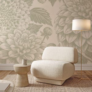 May include: A cozy living room scene featuring a cream-colored boucle armchair, a small beige side table, and a gold floor lamp. The backdrop is a floral wallpaper in shades of beige and taupe, creating a warm and inviting atmosphere.