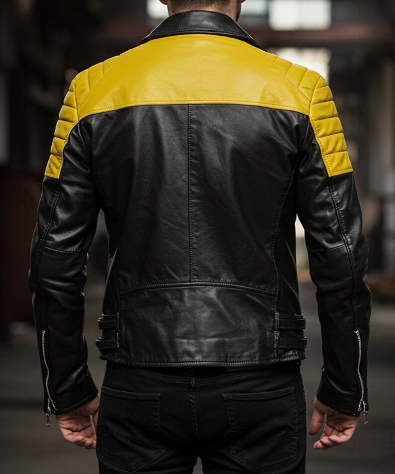 May include: Black leather jacket with a yellow shoulder and upper back panel. The jacket has quilted shoulder detailing, a zipper closure, and a tailored fit. The model is wearing black jeans.