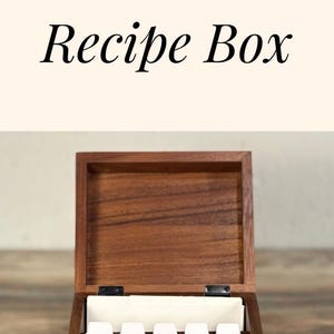May include: A wooden recipe box with the text "Ginger's Recipes" and a floral design engraved on the lid. The box is open, revealing dividers inside. The words "Personalized Recipe Box" are also visible.