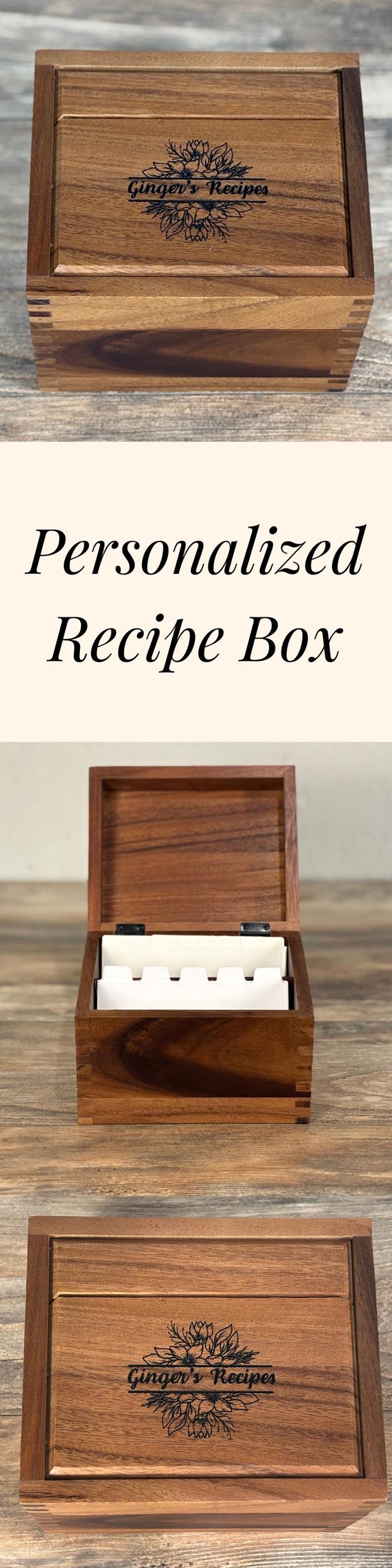 May include: A wooden recipe box with the text "Ginger's Recipes" and a floral design engraved on the lid. The box is open, revealing dividers inside. The words "Personalized Recipe Box" are also visible.