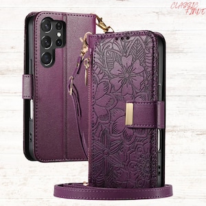 May include: A purple phone case with a floral embossed design. The case has a magnetic clasp, a wrist strap, and a shoulder strap. The phone case is shown open and closed. The brand name "CLASSIC FINDE" is in the top right corner.