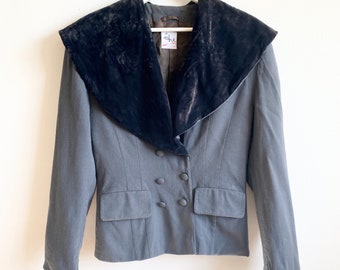 May include: A grey blazer with a large black velvet collar. The blazer has a double breasted closure with four buttons. The label on the blazer reads "shu."
