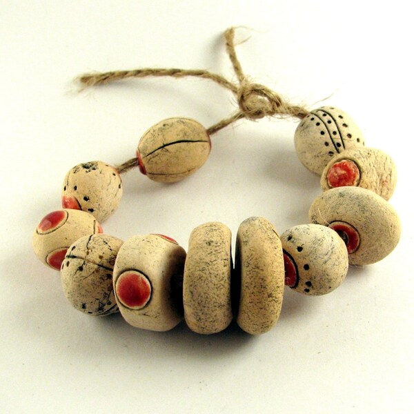 A thread in a tapestry -- 10 handmade ceramic beads with red accents: textured with rivets, pale white, matte, steampunk supplies