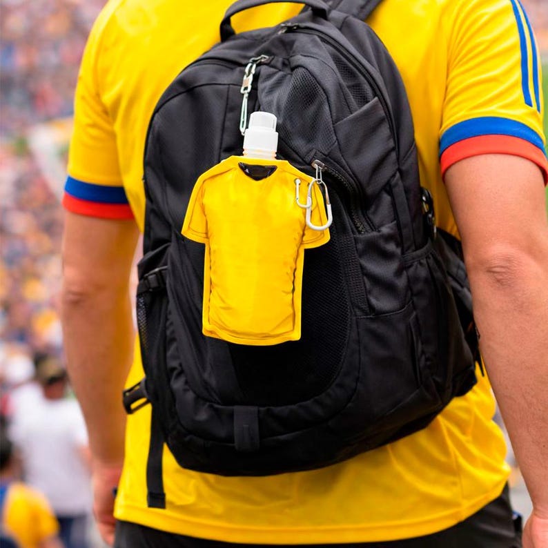 May include: A black backpack with a yellow shirt-shaped water bottle attached via a carabiner. The water bottle has a white cap and is hanging on the outside of the backpack. The person is wearing a yellow shirt.