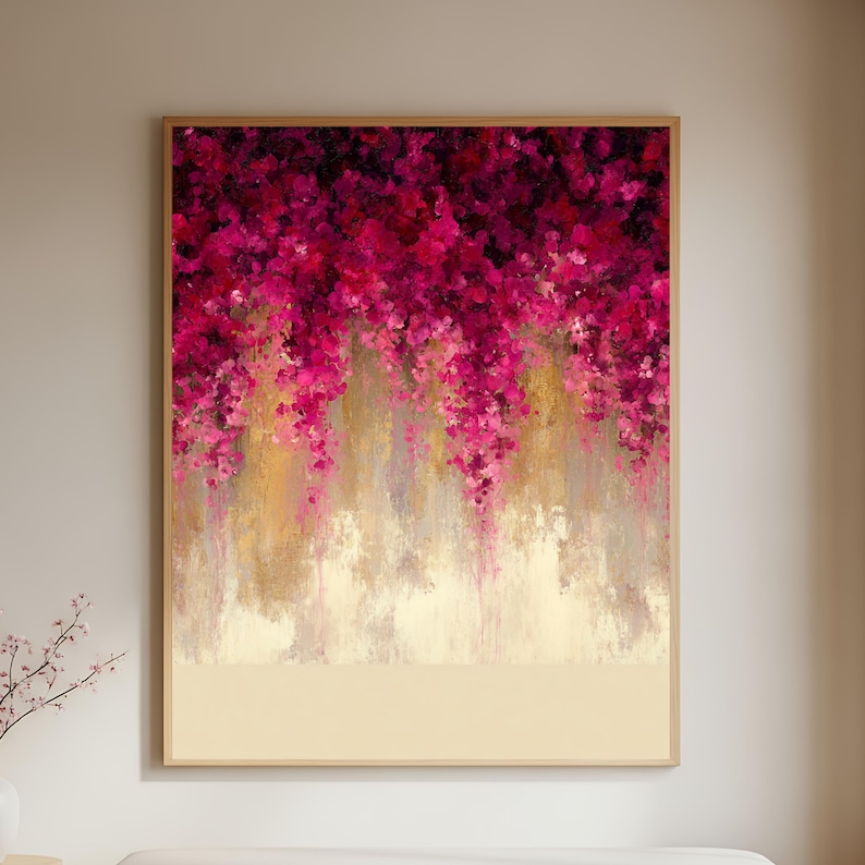 May include: Abstract floral painting in a wooden frame. The artwork features a cascade of magenta and pink flowers against a backdrop of gold and beige tones. The bottom portion of the painting is a solid beige color.